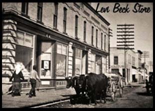 Picture of original building circa early 1900's. Two people walking on sidewalk and ox driven cart sitting on the street out front of the building.