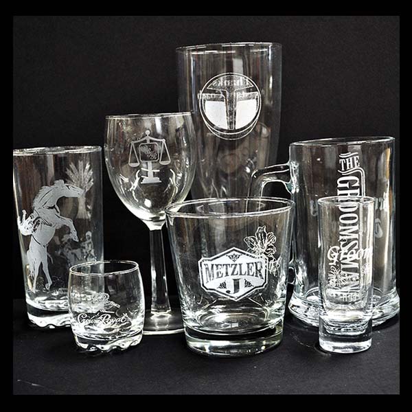 Thumbnail of various sized glasses with laser engraved images on them.